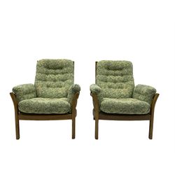 Ercol - ash framed three seat sofa (W193cm, H96cm, D85cm), and pair of matching armchairs (W81cm), with upholstered loose cushions in green foliage patterned fabric 