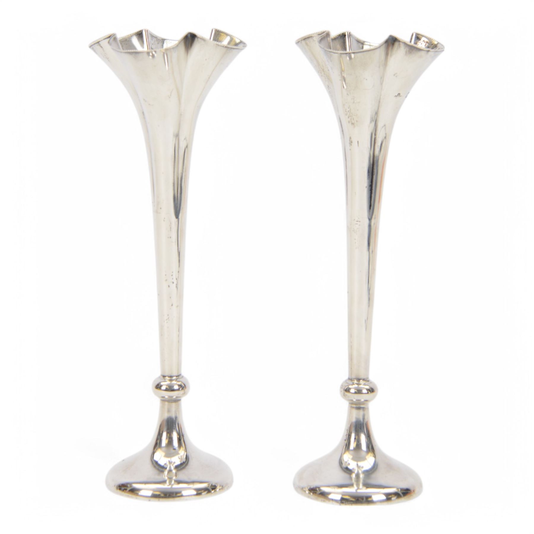 Pair of Victorian silver mounted trumpet vases, with fluted beaded rim, tapering knopped stem and upon circular weighted foot, hallmarked Horace Woodward & Co Ltd, London 1898, H22cm