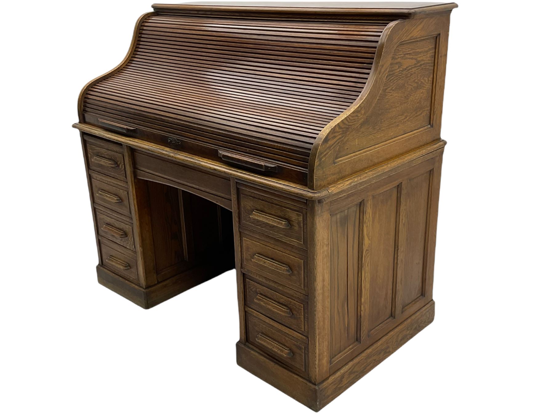 Early 20th century oak roll top desk, the tambour roll enclosing fitted