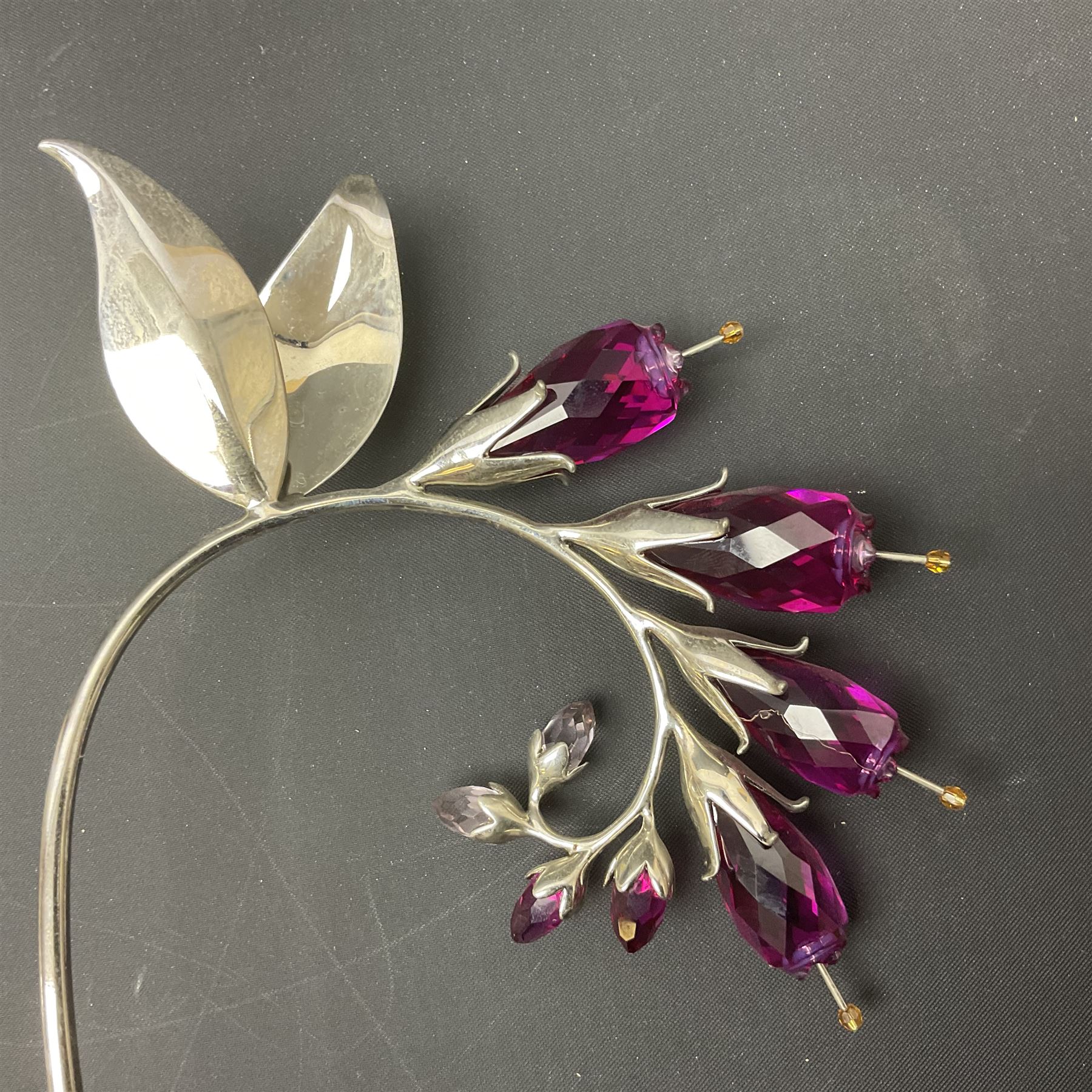 Eleven Swarovski Crystal flowers, to include violet, sunflower, delphinium, forget-me-not and lily-of-the-valley, each on stylised metal stems, tallest H23cm