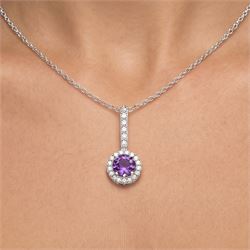 Early 20th century white gold silver amethyst and diamond pendant, round cut amethyst, surrounded by seventeen old cut diamonds, suspending from a five stone diamond set bail, to a silver chain necklace, total diamond weight approx 0.40 carat