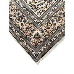 Persian Kashan ivory ground rug, decorated with curled leafy branches and palmettes, the border with scrolling design decorated with further palmettes, within floral pattern guard stripes