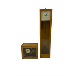 A mid-20th century Gent of Leicester(Blick Electric) Pulsynetic Master Clock in a full length glazed wooden case, with a square white dial with Arabic numerals, minute markers and baton hands, with pendulum and a record card dating from the 1970’s. 
This master clock would have been wired to send time signals to other slave dials in a large building, frequently used in hospitals, schools and factories during the 20th century
With a second electrical movement housed in a glazed square cabinet.


