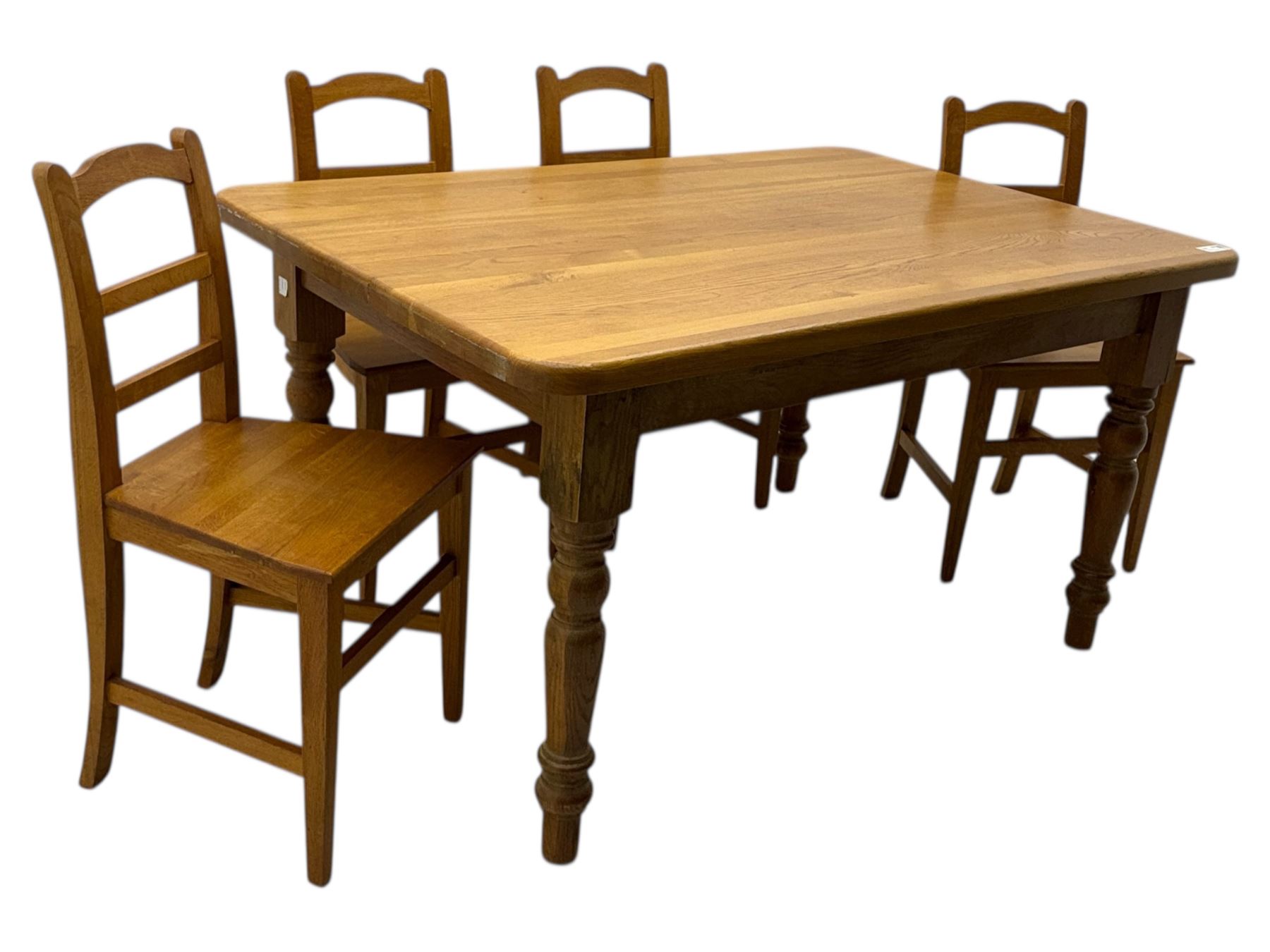 Contemporary light oak farmhouse dining table, and four oak ladder back dining chairs, rectangular top with rounded corners, raised on four turned baluster legs in natural lacquered finish, chairs with three horizontal slats beneath a shaped top rail, solid seat and square section legs united by stretchers