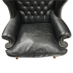 Pair of quality Georgian design wingback club armchairs, the high arched back with wings over rolled arms, upholstered in back-buttoned black leather with loose seat cushion, raised on foliate carved cabriole supports