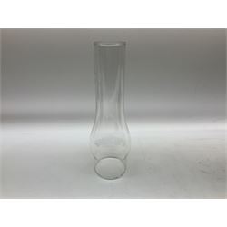 Victorian table oil lamp with black glazed stepped circular base, reeded brass column, moulded pink glass reservoir, duplex burner and frilled rim frosted glass shade with clear glass chimney H69cm