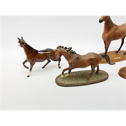 Four Royal Doulton horse figurines, comprising Red Rum, Arkle, and the Winner DA154, and another modelled as a prancing bay horse, largest H32cm. (4). 