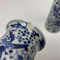 Pair of Chinese blue and white cylindrical vases, decorated with bird and flowers surrounding central figures holding a large vase, H20cm