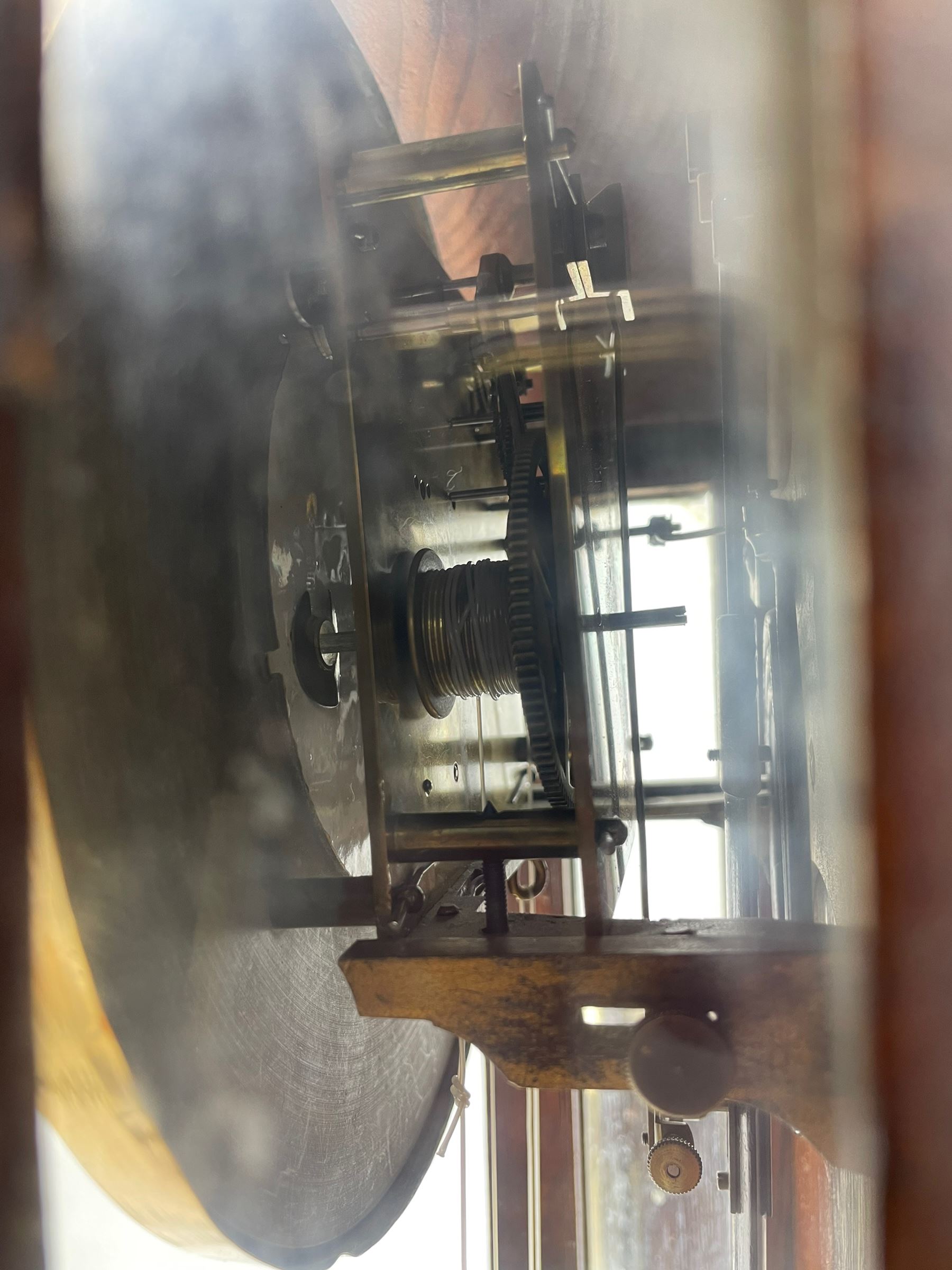 Lenzkirch – 8-day walnut cased weight driven Vienna regulator manufactured 1877-1878, with a break-arch pediment surmounted by a turned finial on a raised cavetto molding, fully glazed arched  door flanked by long ring turned pendants, flat base with open fretwork and two short pendants,  two piece enamel dial within a brass slip, Roman numerals, minute track and pierced steel hands, wooden pendulum with a brass faced bob, two brass cased weights and pulleys, dead beat escapement with a rack striking movement sounding the hours and half hours on a coiled gong, movement serial number 421410. 
Lenzkirch were one of Germanys most highly respected clock manufacturers of the 19th century, founded in the late 1850s the company produced movements and cases of high quality up until 1932.
