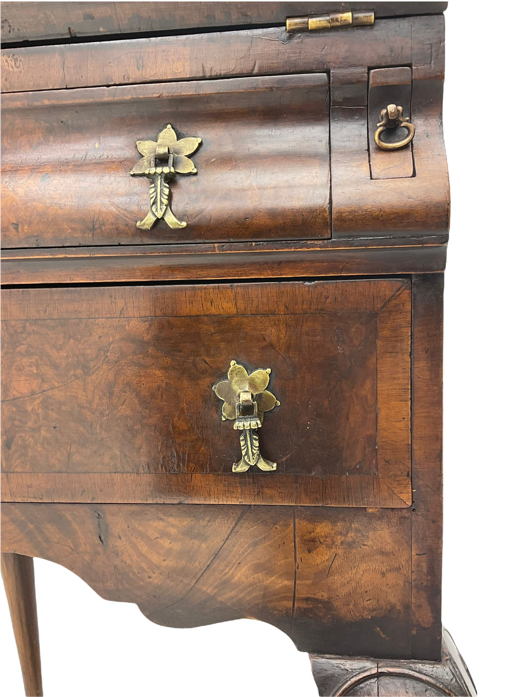 Small early 20th century Queen Anne style bookcase on bureau secretaire, the moulded arched pediment over mirrored door in shaped frame, the bureau fitted with fall front enclosing curved fitted interior, cushion moulded drawer over single drawer, on scroll and shell carved cabriole supports