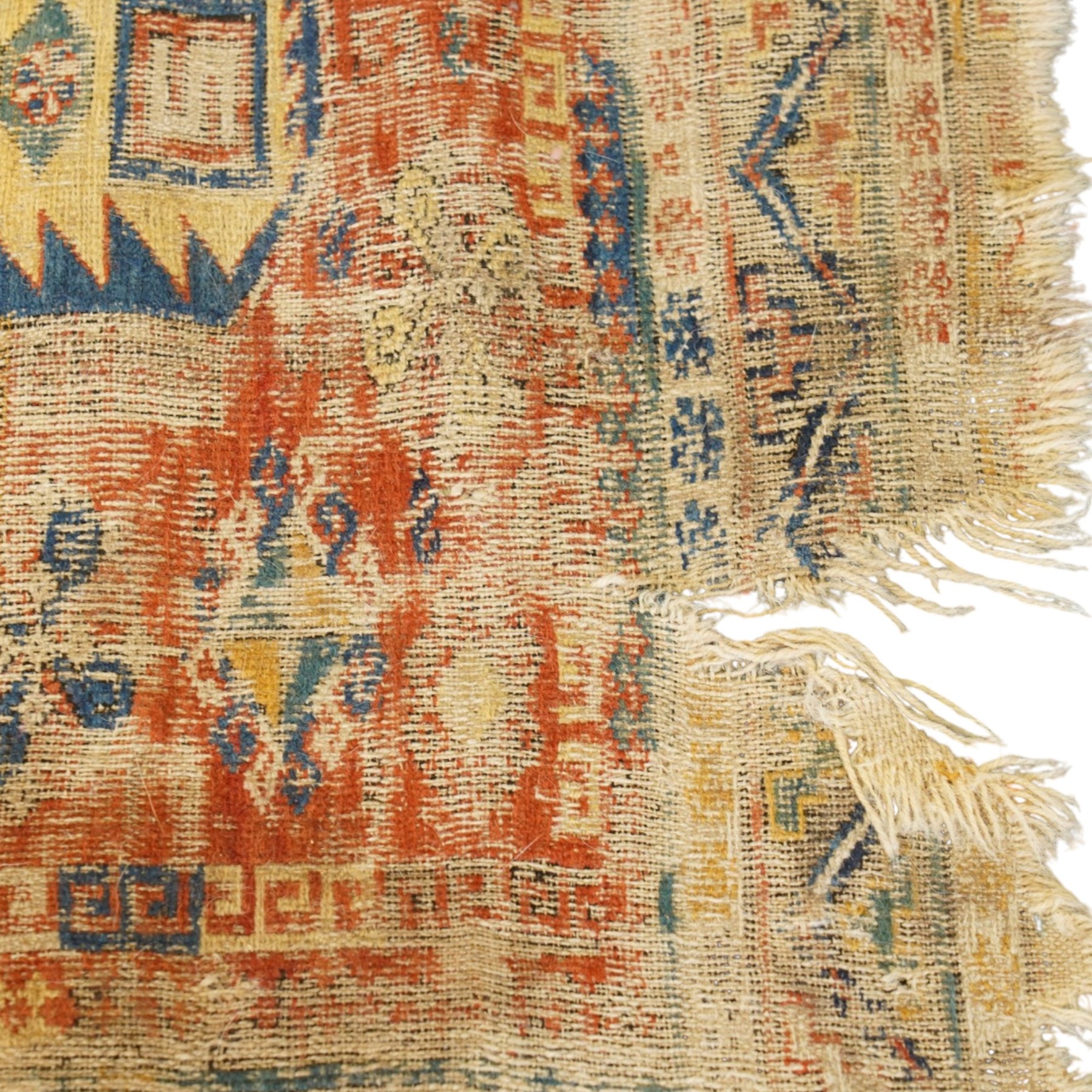 Antique Caucasian crimson ground carpet. the field decorated with three geometric indigo medallions with surrounding geometric motifs and guard lines