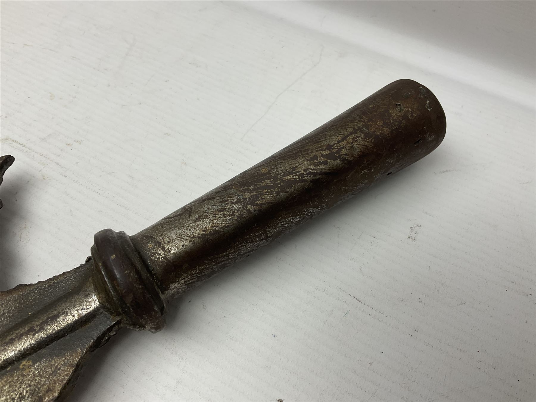 Moroccan jambiya dagger with 24.5cm plain curved blade stamped LONDON to the ricasso area, the hilt and scabbard overlaid with plain sheet brass to the back and ornate silver coloured metal to the front; waisted grip and arched pommel; two pyramid mounts to the scabbard L41cm overall; large billhook with curving blade and stacked leather washer grip; and a reproduction halberd blade (3)