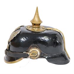 WWI Prussian M1895 Pickelhaube, the black leather skull with brass spike finial, brass eagle helmet plate and leather chin strap, one side with a black cockade,  the other black and red, with leather lining