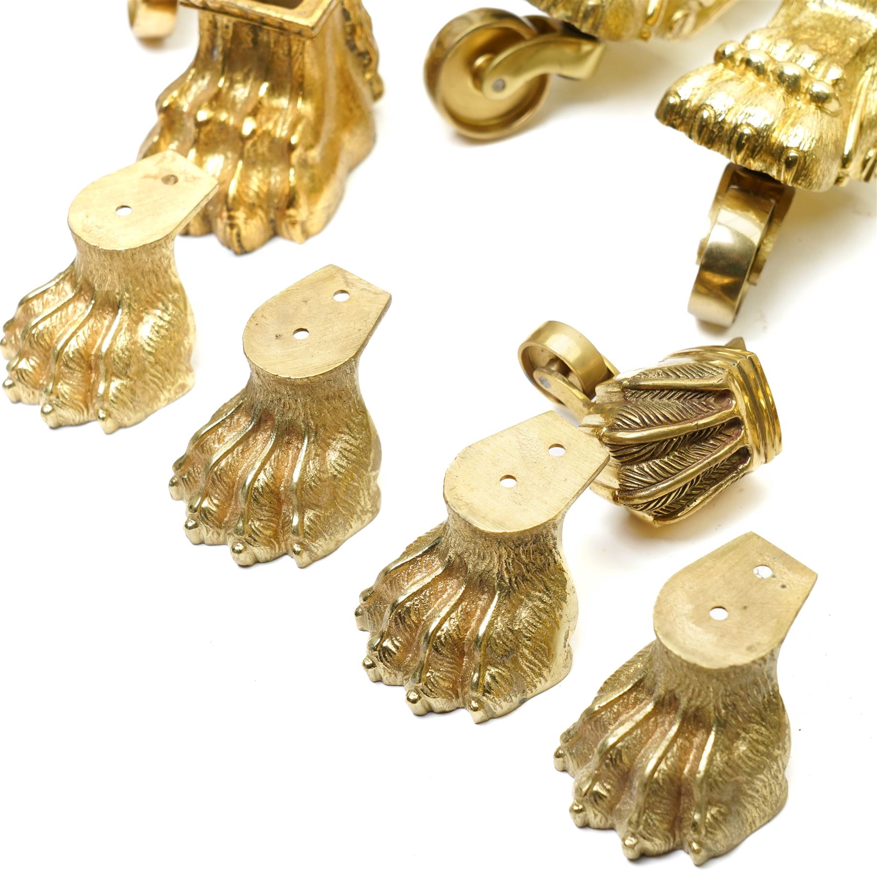 Set of four period design lacquered brass paw furniture castors by Beardmore, London, set of four matching smaller castors and a quantity of various brass castors   
Provenance: property of a Nobleman