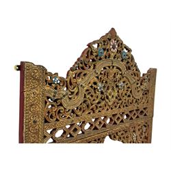 Large North African design carved and painted wall mirror, decorated with floral motifs, pierced foliate scrolls, inset mirrored panels, and colourful painted detailing, enclosing an oval bevelled mirror plate