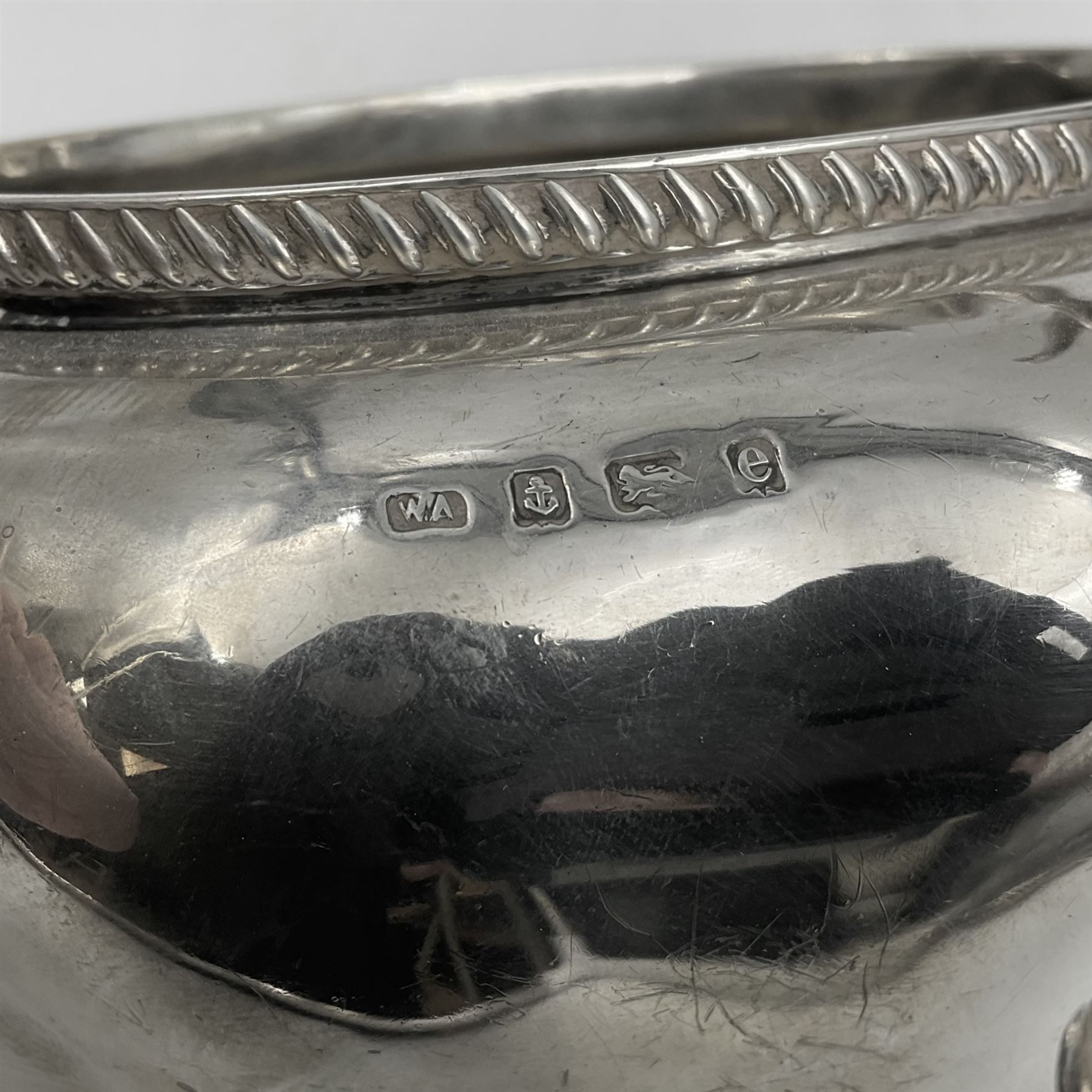 Five piece Edwardian silver tea service, comprising teapot and coffee pot, each with ebonised scroll handle, tea caddy with hinged cover, twin handled open sucrier, and milk jug, each of rounded bombe form, upon four paw feet, hallmarked William Adams Ltd, Birmingham 1904 and 1905, coffee pot H26cm
