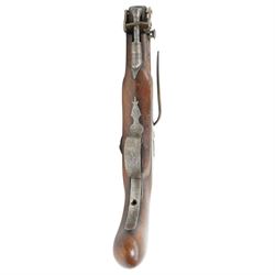 19th century percussion pistol with octagonal barrel, captive ramrod, belt hook, scroll engraved lock and trigger guard and walnut stock L25cm  