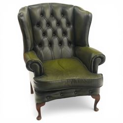 Queen Anne style green leather wingback armchair, shaped high back with button tufted upho...