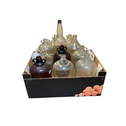Eleven glass demijohns, including two brown glass examples 