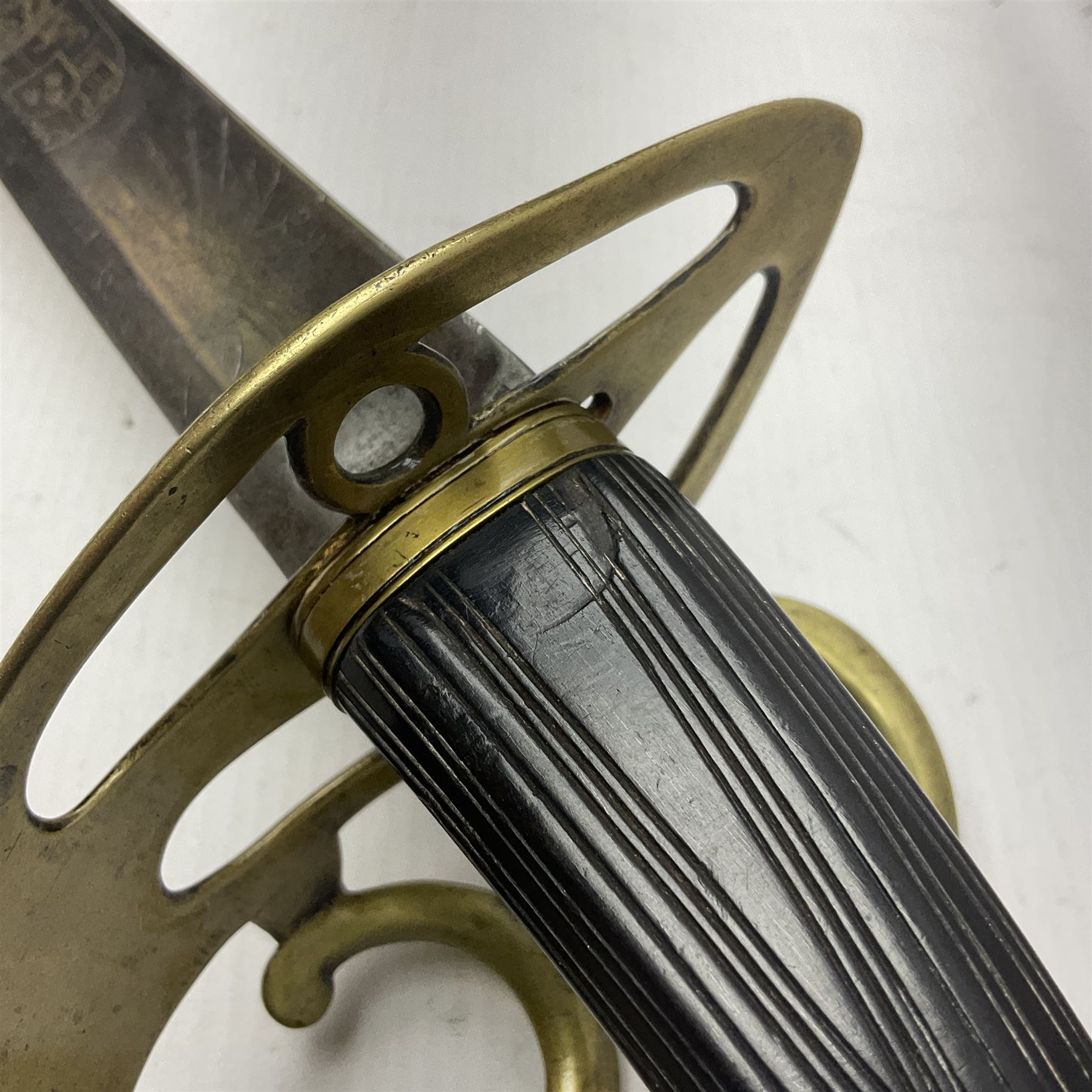 Late 18th century sword, the Spanish 79.5cm curving fullered blade engraved with the Royal Cypher, battle trophies and 'Viva Espania' banner, French Sabre de Mineur brass three-bar hilt with ebonised reeded grip L93.5cm overall (no scabbard)