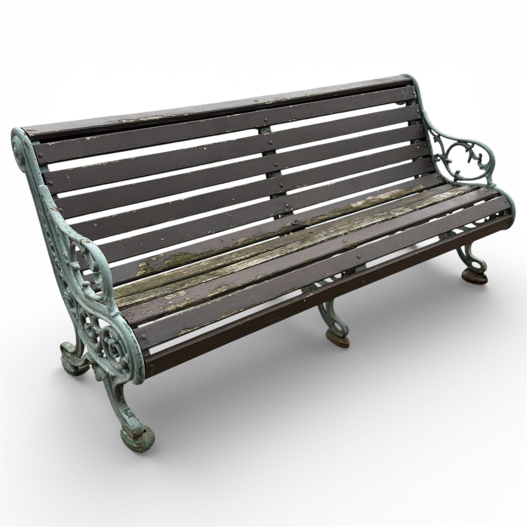 Victorian cast iron garden bench with dark wooden slats and ornate green painted ends.