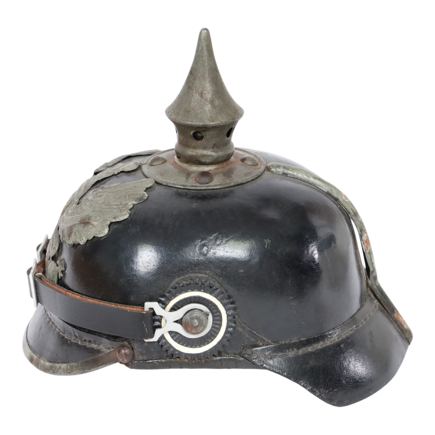 WWI Prussian M1915 Pickelhaube, the black leather skull with removable steel spike finial, steel eagle helmet plate and leather chin strap, one side with a black cockade, the other black and red