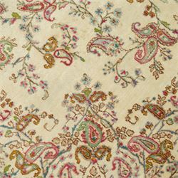 Persian Isfahan cream ground rug, overall floral design, sparse field decoration with trailing flower head and Boteh motifs, repeating floral pattern boarder with repeating motifs 