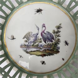 Pair of 19th century German openwork chestnut baskets, with twin handles and scrolling gilt border and star rim, painted to the centre with birds and insects, D22cm 