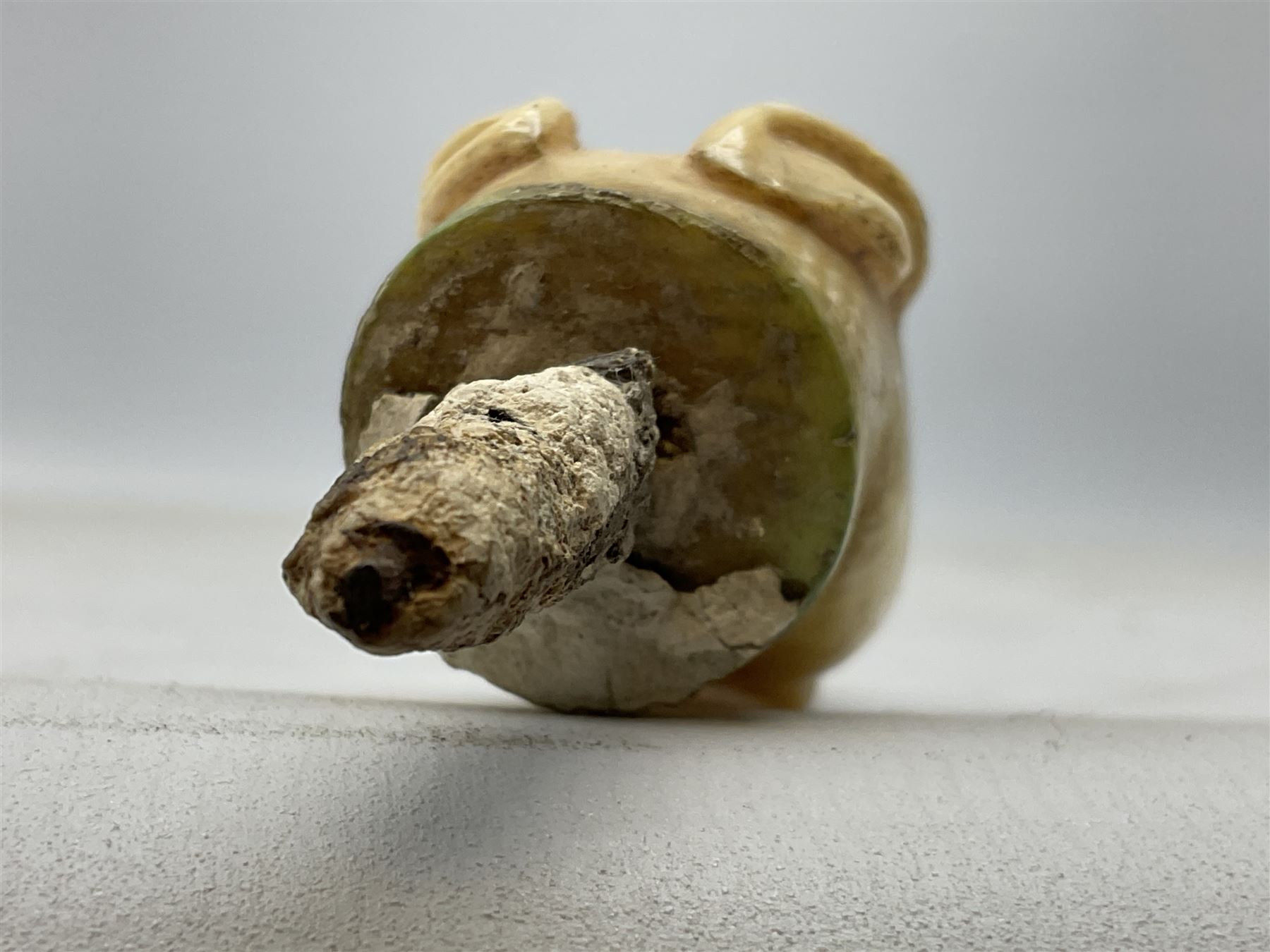 19th century carved ivory walking cane handle, modelled as the head of a greyhound with inset glass eyes, together with a further 19th century ivory example, modelled as a caricature of a gentleman's head, (2)