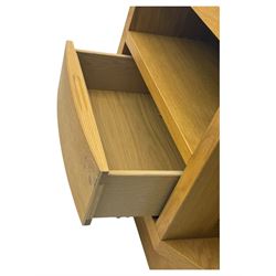 Contemporary light oak corner television stand, hexagonal top with central open section and lower drawer, shaped sides on integral plinth