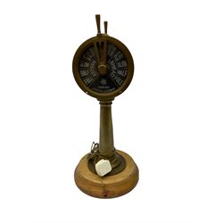 Early 20th century, illuminating brass ship's telegraph by Chadburns of Liverpool and London, on a circular wooden plinth, H55cm
