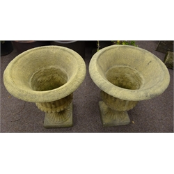  Pair of composite stone Campana shaped urns, reed and gardroon moulded bodies, on square section base, D59cm, H75cm  