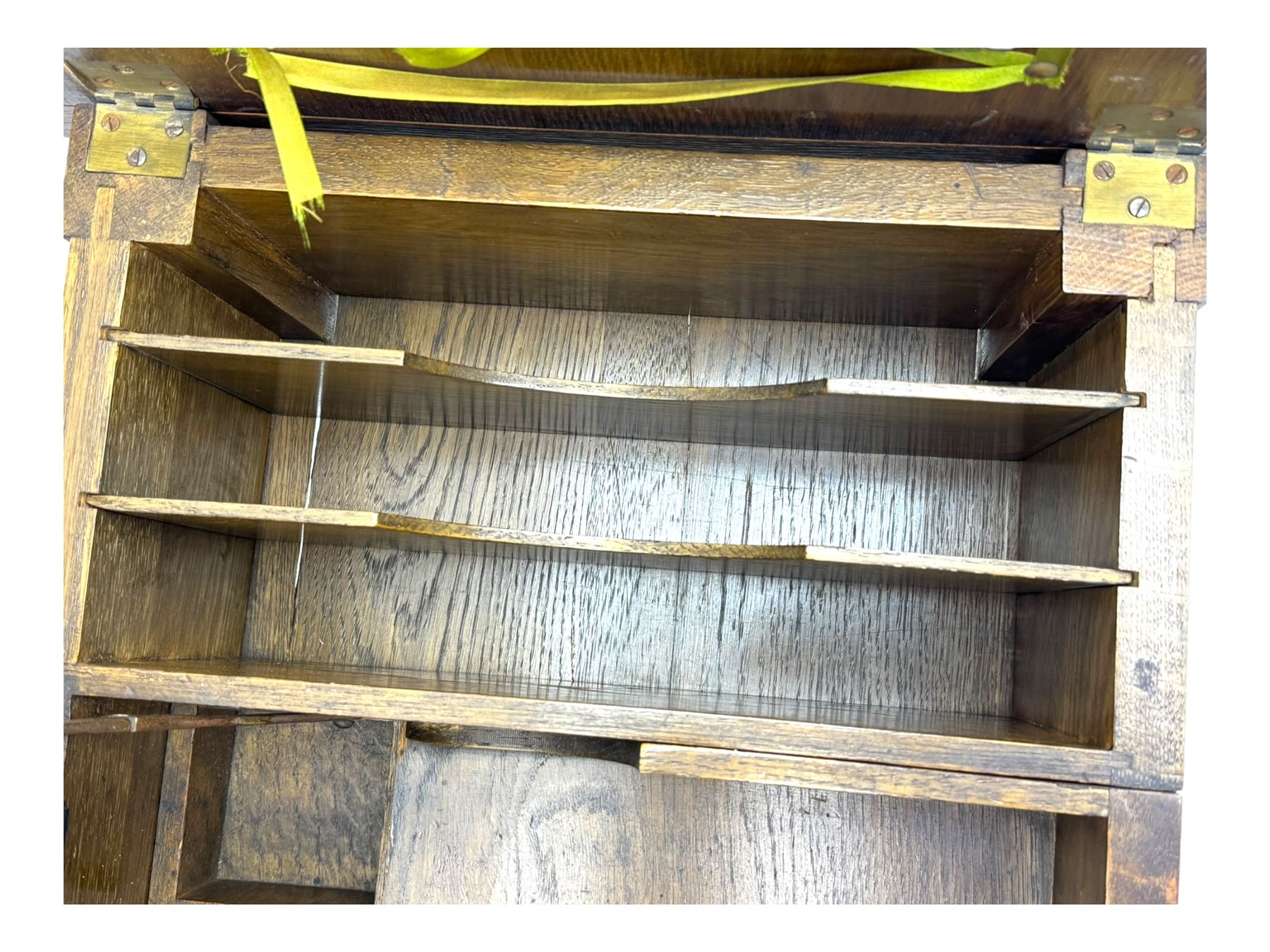 Edwardian oak metamorphic 'Britisher Writing Table', rectangular hinged top revealing correspondence compartments and hinged writing surface with underside storage, flanked by twin hinged compartments with dividers, on turned supports
