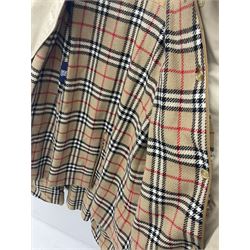 Ladies Burberry double breasted trench coat, with belt and detachable woollen gilet, in traditional cream colour with Burberry check lining, together with a gentlemans Burberry single breasted trench coat, both L112cm