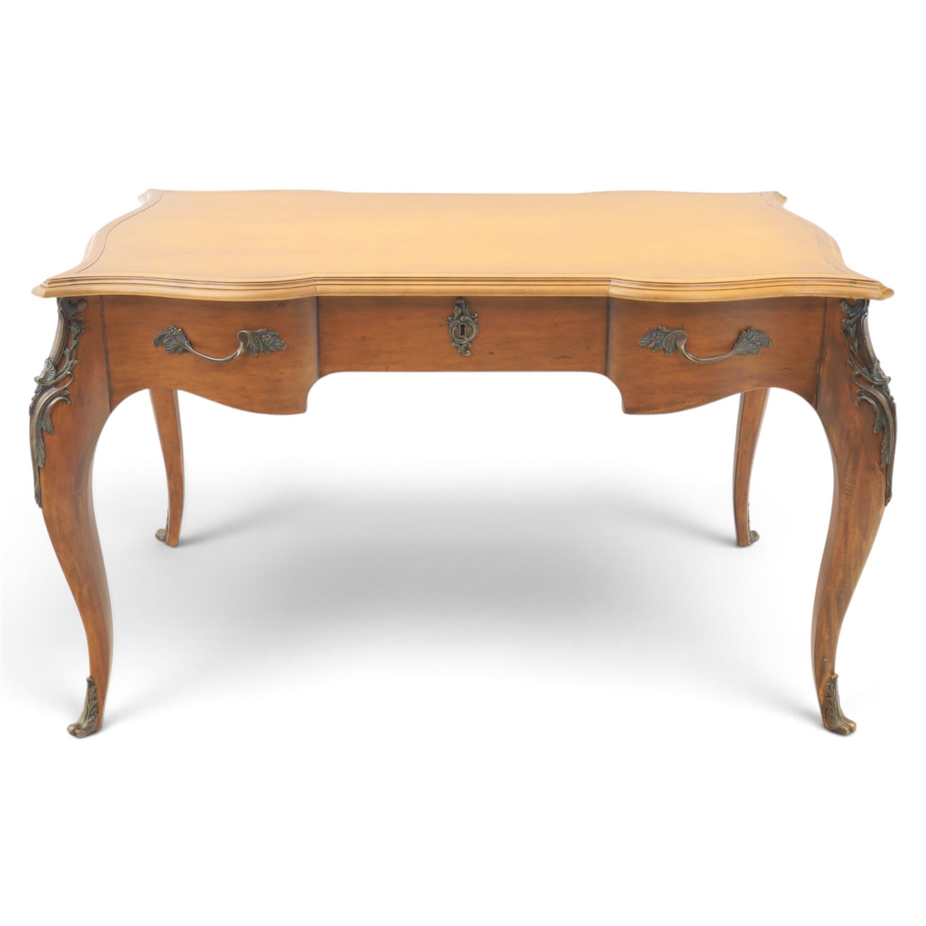 And So To Bed - Cherrywood serpentine dressing table, two drawers with brass handles foliate design with applied gilt mounts, raised on cabriole legs with gilt caps
