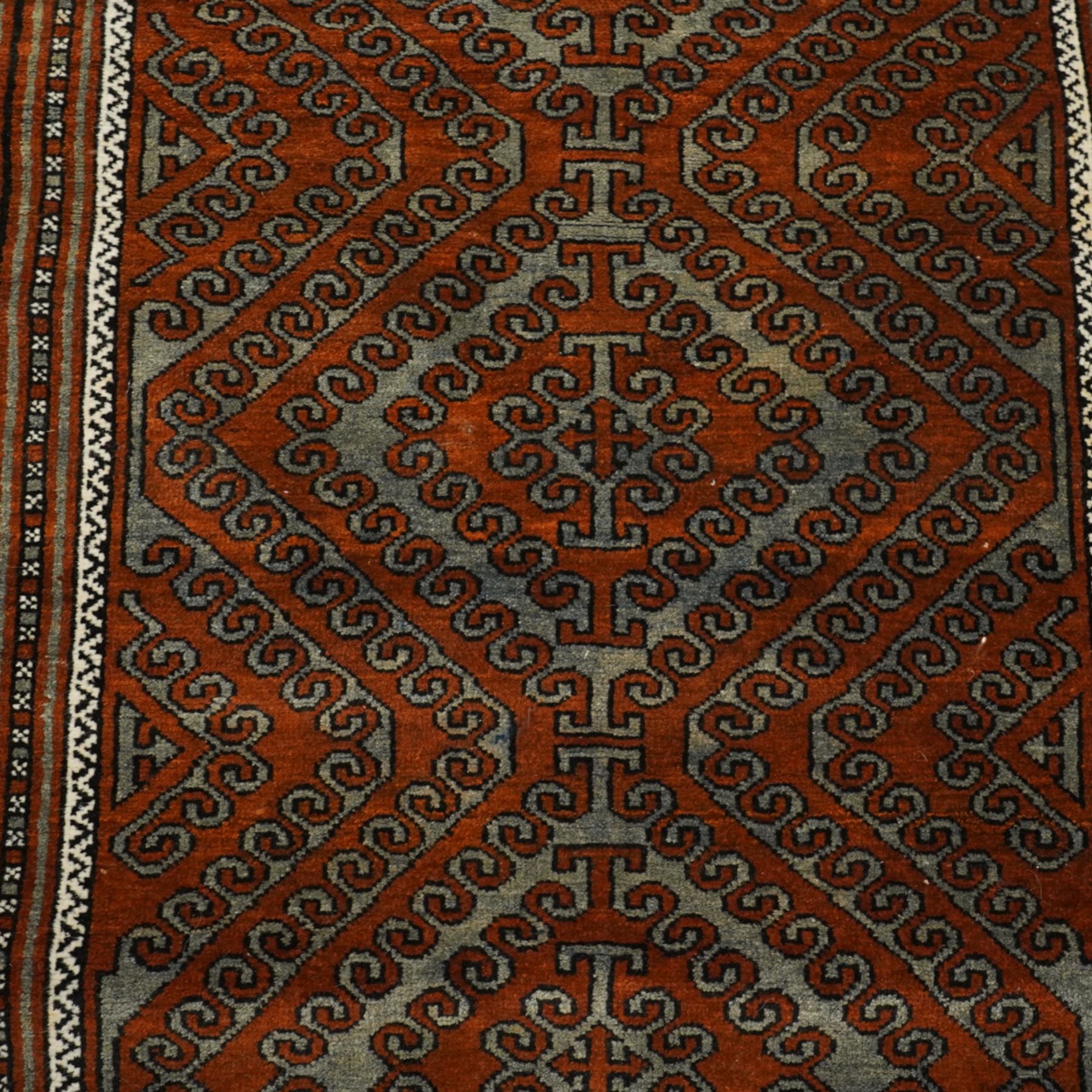 Afghan Turkmen Ersari hand-knotted rug, warm brown field decorated with a vertical arrangement of the elongated geometric guls formed by ram's horn hook motifs, enclosed by narrow ivory guard stripes, and a broad main border, with cotton fringe ends 