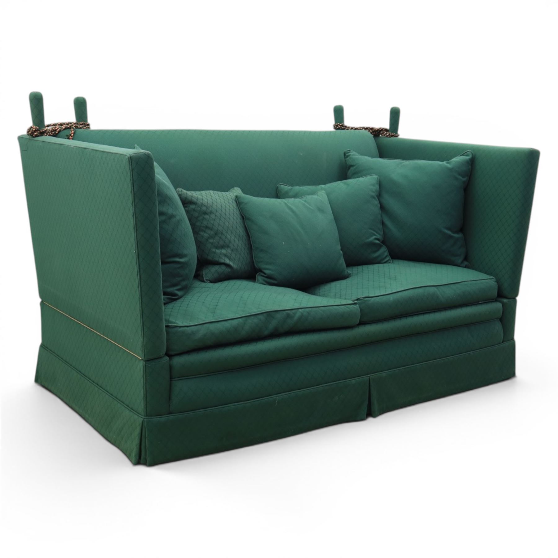 Late 20th century two-seat Knole sofa, covered in green woven fabric with lattice pattern, high panelled back and hinged drop arms secured by braided cords, loose cushioned seat and back with additional scatter cushions, on plinth base