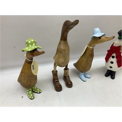 Quantity of the Duck Company UK DCUK carved bamboo root ducks, modelled wearing rain hats and rain boots etc, together with other similar carved wood ducks, tallest H26cm