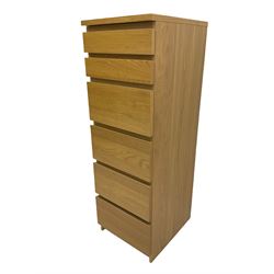 IKEA light oak finish chest, fitted with hinged vanity top, above six graduating drawers 