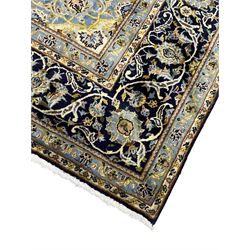 Persian Kashan indigo ground rug, central floral pattern pole medallion, the field decorated with palmettes united by trailing branches, repeating floral pattern border within guard stripes