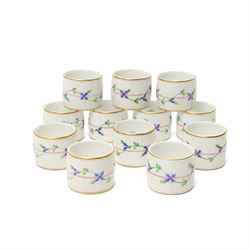 Set of twelve Herend porcelain napkin rings painted with trailing flowers and leaves on a ...