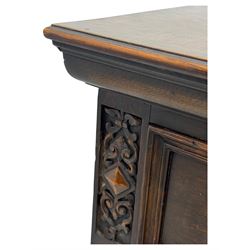 Jacobean-style oak dresser base with two frieze drawers above three cupboards with panelled and moulded decoration, fitted with drop handles, supported on bun feet, circa 1900
