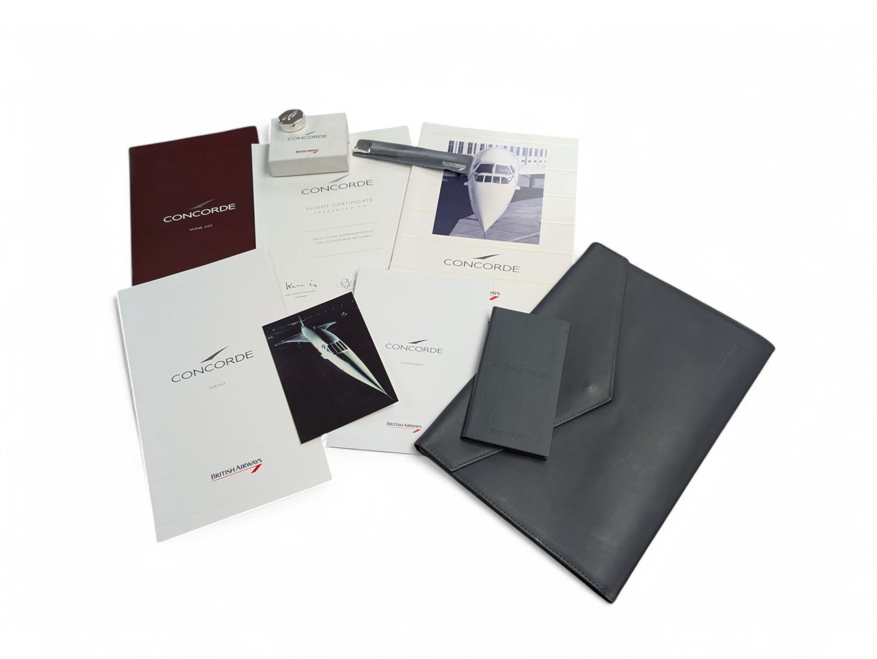 Collection of British Airways Concorde memorabilia, including silver pill box, menus, certificate, etc