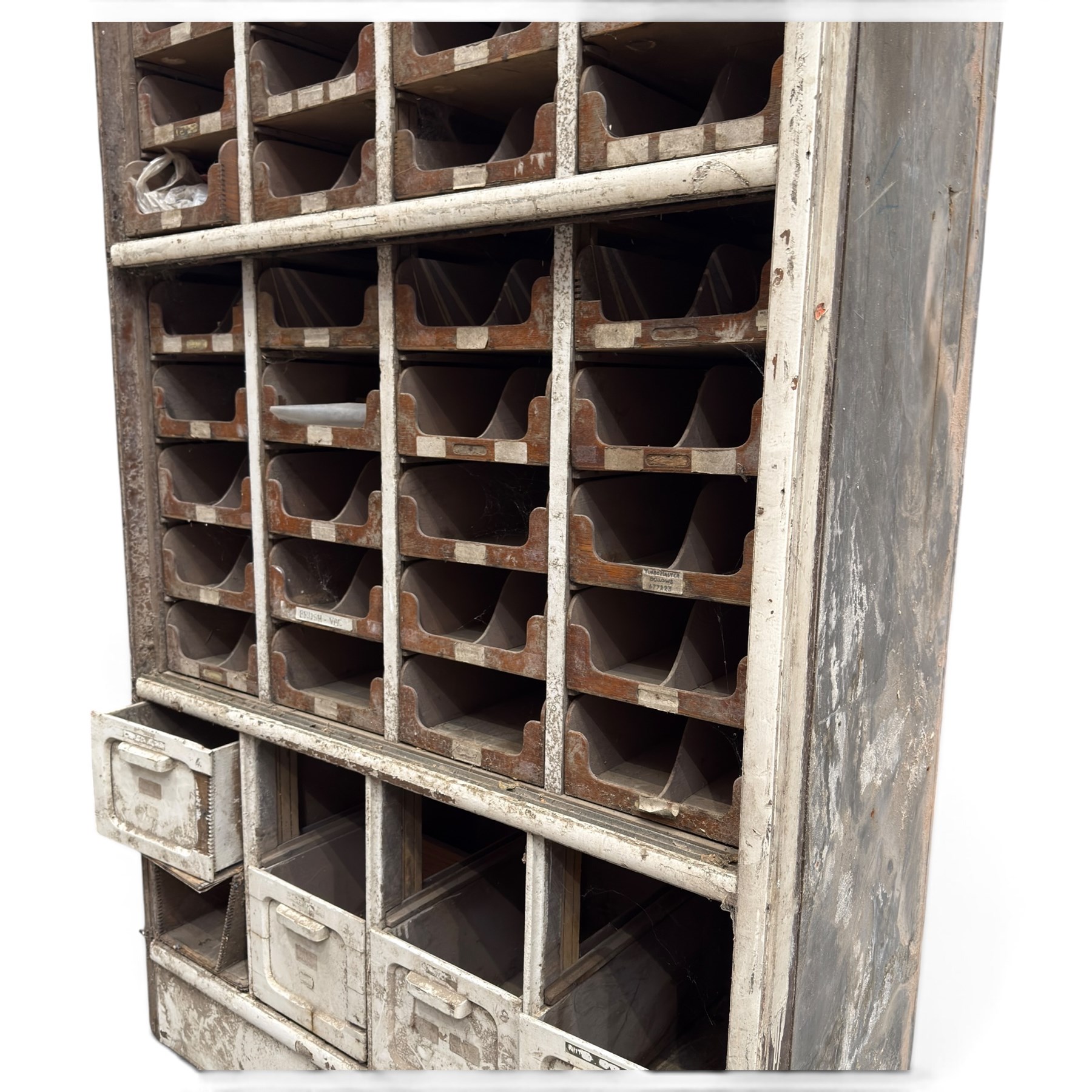 F Pollard & Co - late 19th century rustic haberdashery shop cabinet, fitted with an assortment of forty sliding trays, with drawers fitted to base, in antique white-painted finish