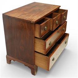 Small 19th century mahogany chest of drawers, rectangular top with moulded edge over three short and two long drawers, the drawers fitted with brass ring handles and key escutcheons, raised on shaped bracket feet