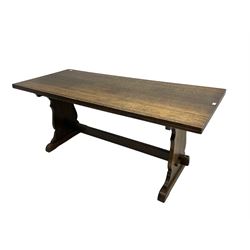 Mid-20th century oak dining table, rectangular top over shaped end supports united by stretcher, on sledge feet