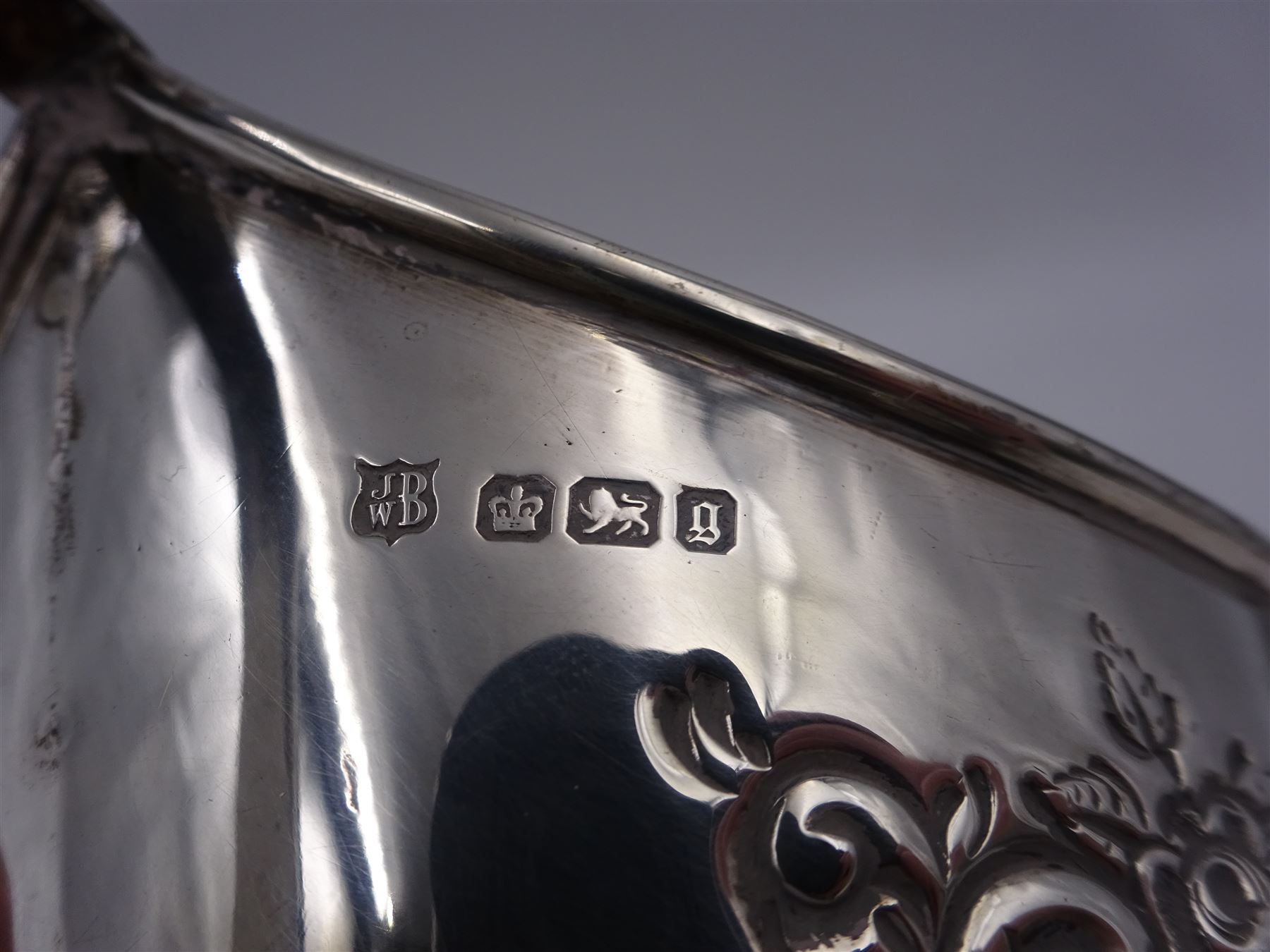 Late Victorian silver milk jug and twin handled open sucrier, each of oval form with angular handles and embossed floral, foliate and C scroll decoration, hallmarked James Deakin & Sons, Sheffield 1899, sucrier with handles H10.8cm