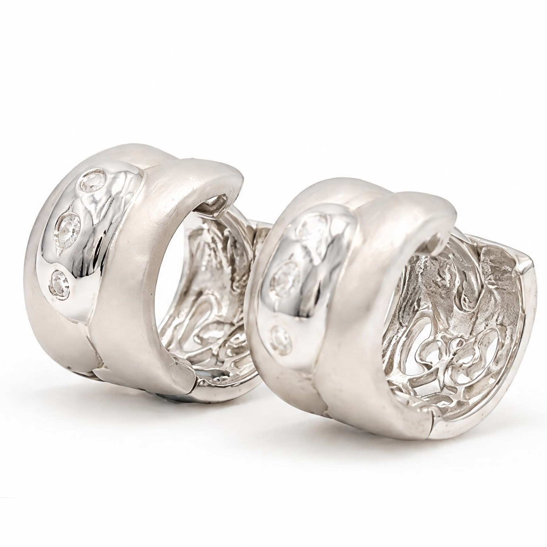 Pair of 18ct white gold diamond brushed and polished hoop earrings, each rubover set with three round brilliant cut diamonds, to a pierced design back, stamped 750