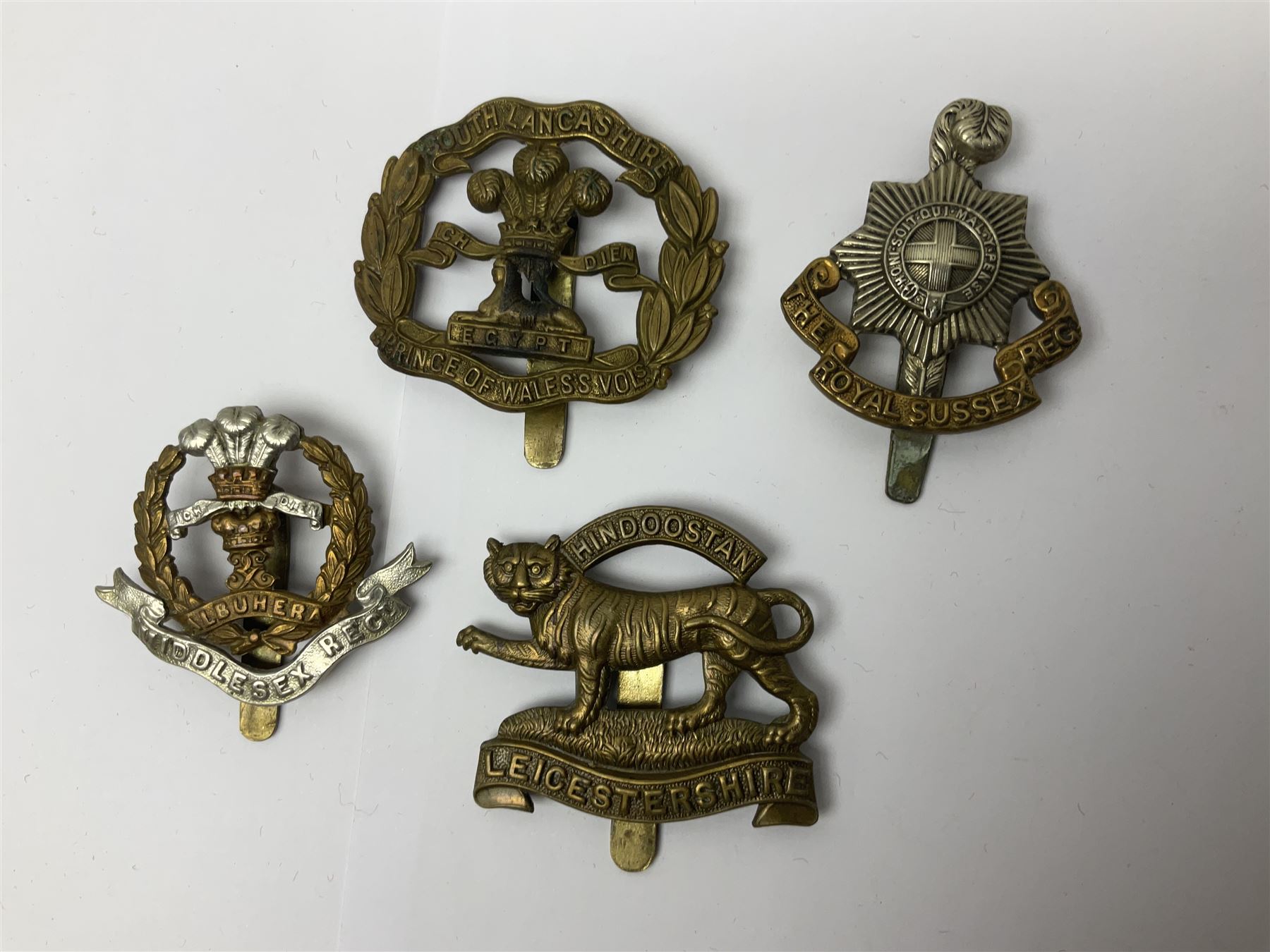 Seventeen regimental cap badges including Dorsetshire, Worcestershire, Staffordshire, Lancashire, Manchester, Middlesex, Berkshire, Bedfordshire etc (17)