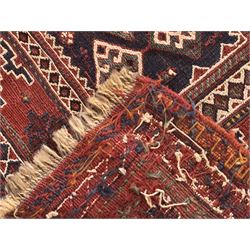 Persian-style wool rug, cream field with floral and geometric motifs, wide floral border (74cm x 142cm); Persian wool rug, beige field with dense floral patterns, narrow floral border (70cm x 144cm); Tribal wool rug, red and navy with diamond motifs (96cm x 60cm); Persian pictorial wool rug, black field with vase, birds, and floral border (70cm x 73cm)